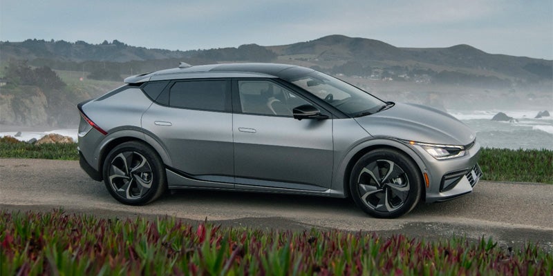 2025 silver ev6 driving along an ocean road