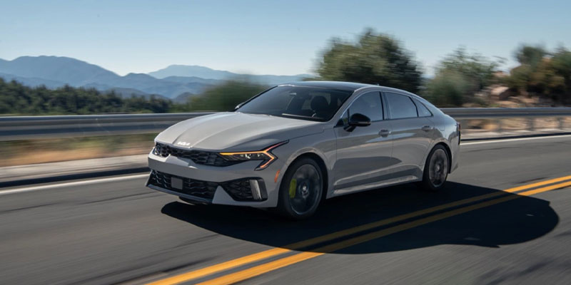 2025 kia K5 driving down a highway