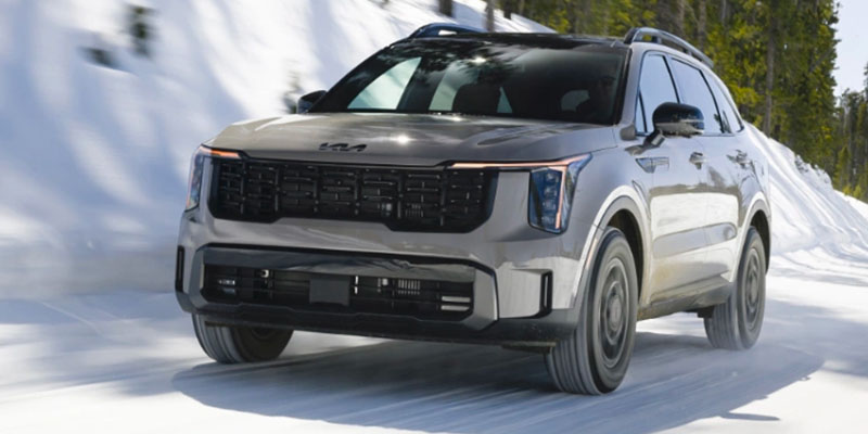 2025 kia sorento plug in hybrid driving down snowy road